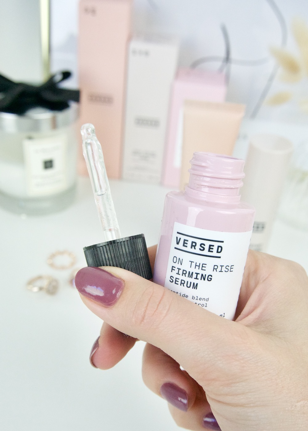 On The Rise Firming Serum in hand